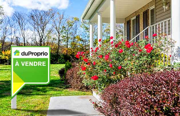 Front of house in the spring with DuProprio On sale sign Front of house in the spring with DuProprio On sale sign